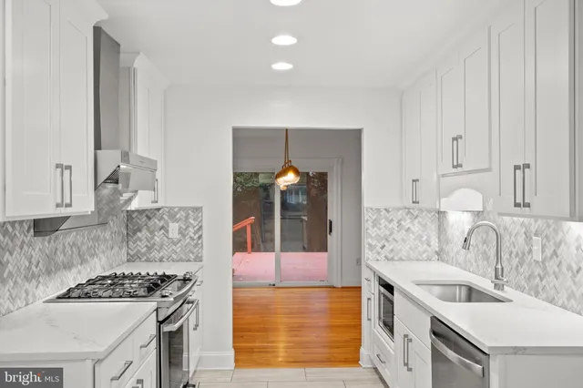 a kitchen with a stove and a sink