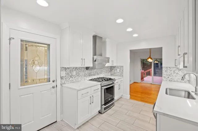 a kitchen that has a sink and a stove