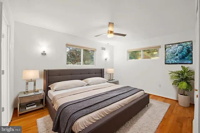a bedroom with a bed and a potted plant