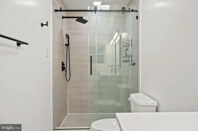 a bathroom with a shower and toilet