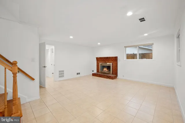 a view of an empty room with a fireplace