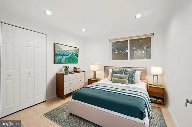 a bedroom with a bed and a dresser