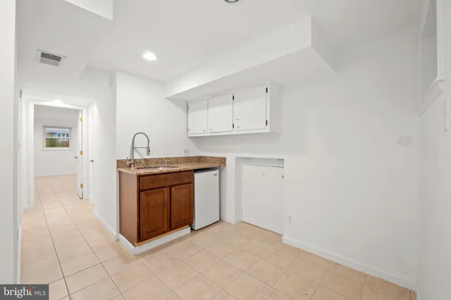 a kitchen with stainless steel appliances granite countertop a sink and a stove