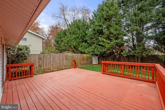 a view of backyard with a deck and wooden floor
