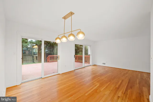 a view of a room with window and chandelier