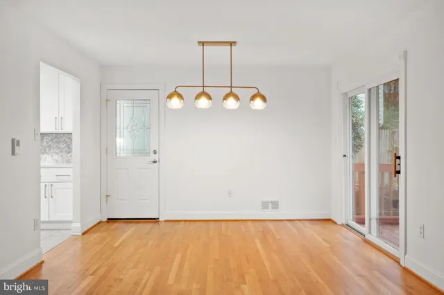 a view of a room with wooden floor and cabinet