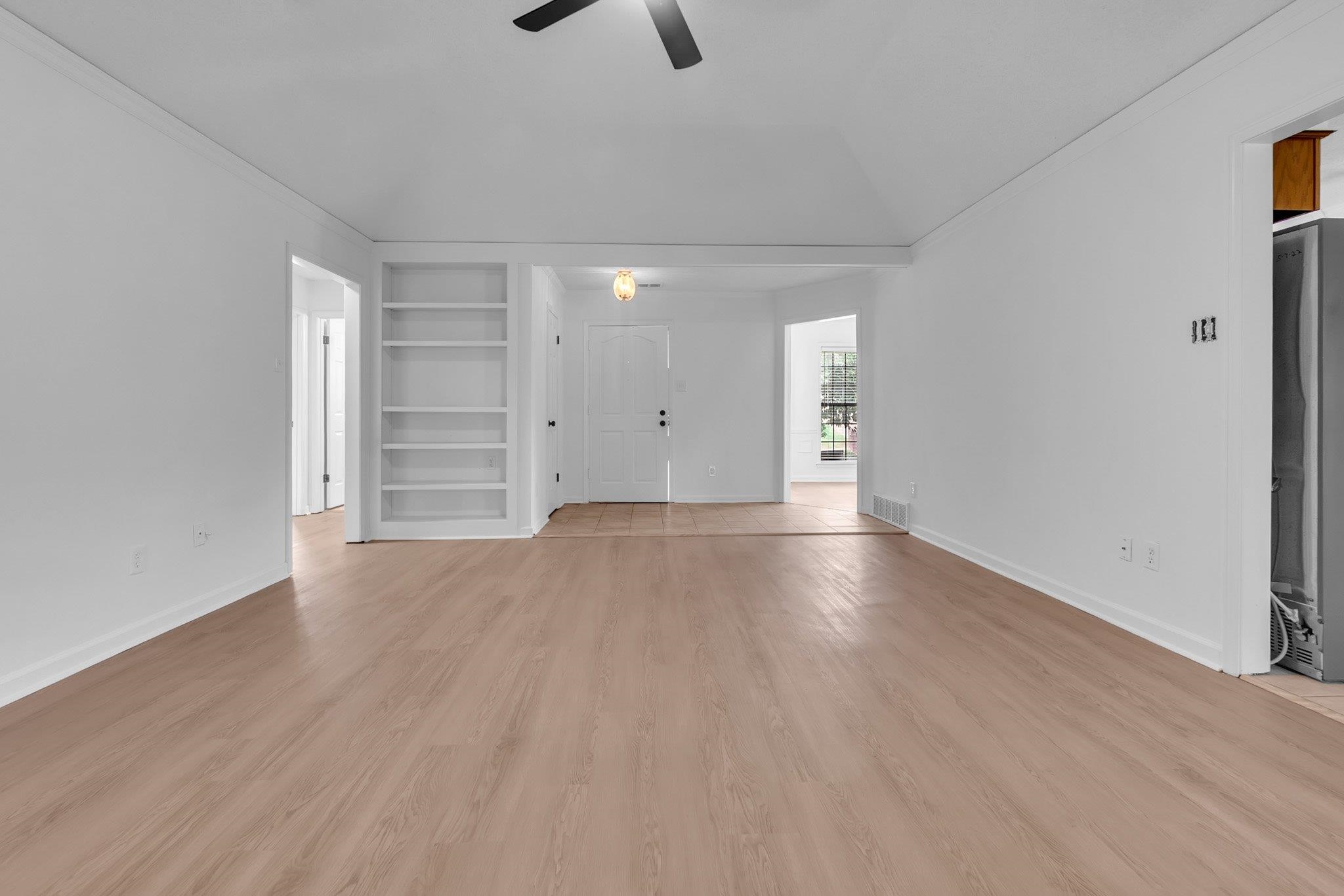 6613 Stephan Ridge Drive Bartlett, TN 38135 - Photo 6 of 24 Spacious room with wood-finish flooring, vaulted ceiling, and built-in shelving