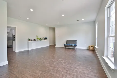 a view of a livingroom with wooden floor and a rug