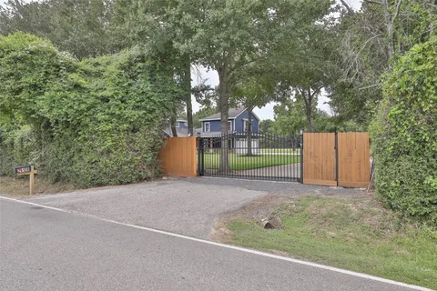 a view of a field with large trees and a small yard