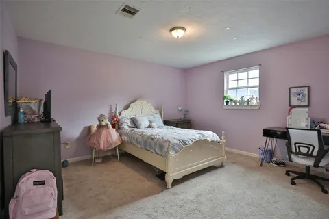 a bedroom with bed and a window