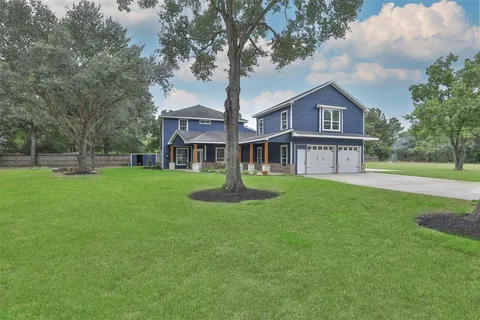 a front view of house with yard and green space