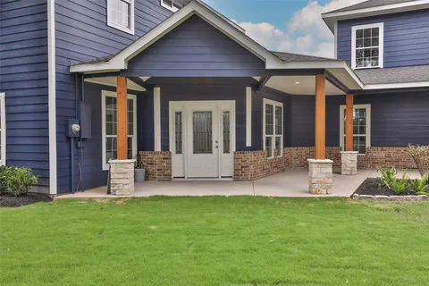 a view of a house with a yard porch and sitting area