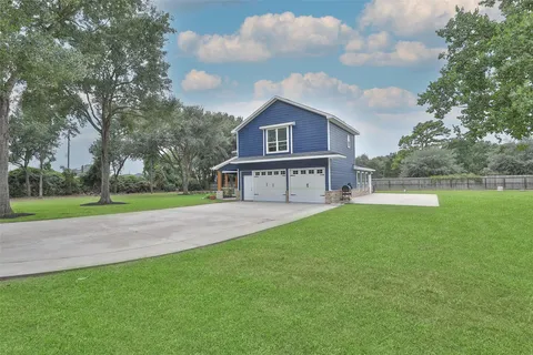 a front view of a house with yard and green space