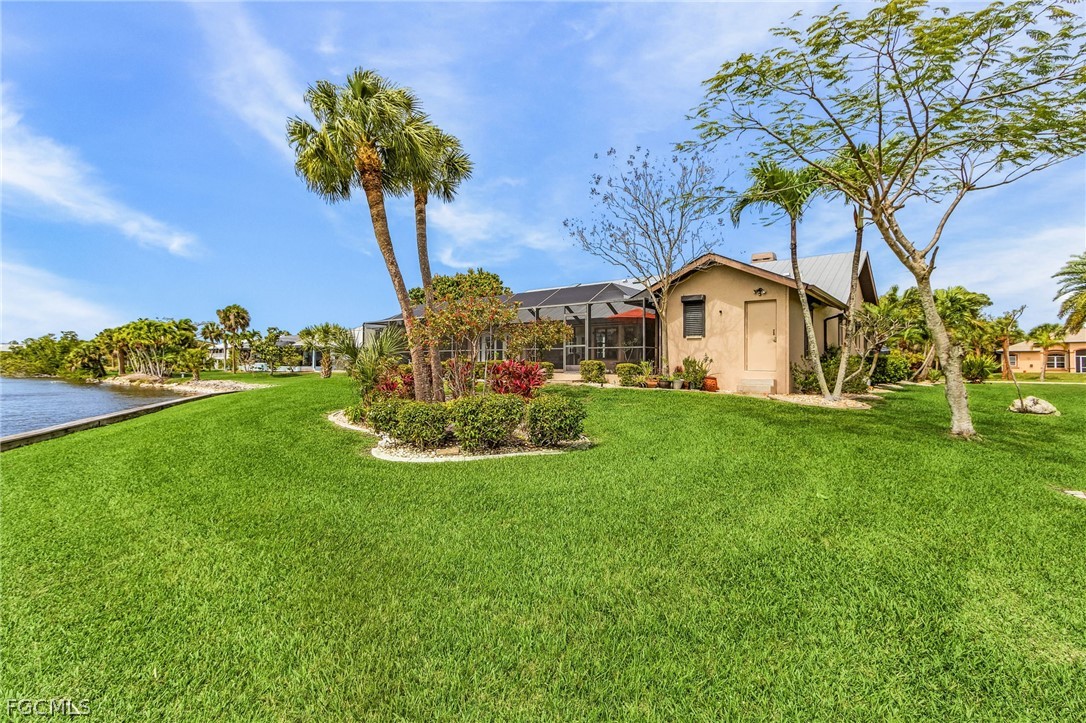 7747 Grande Pine Road Bokeelia, FL 33922 - Photo 38 of 45 a front view of a house with garden