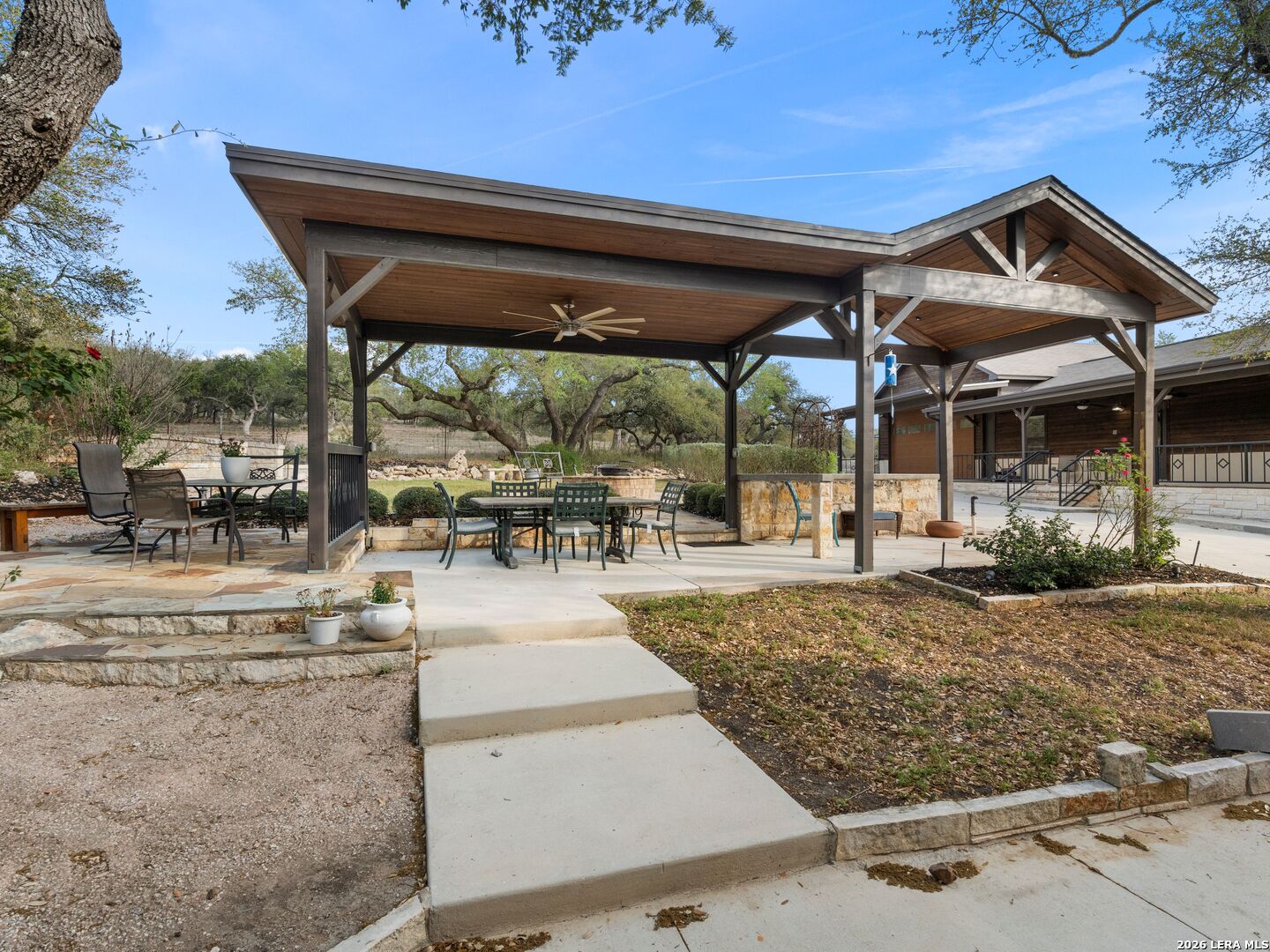 1146 Victoria Avenue Spring Branch, TX 78070 - Photo 88 of 89 a view of a patio with a table and chairs under an umbrella