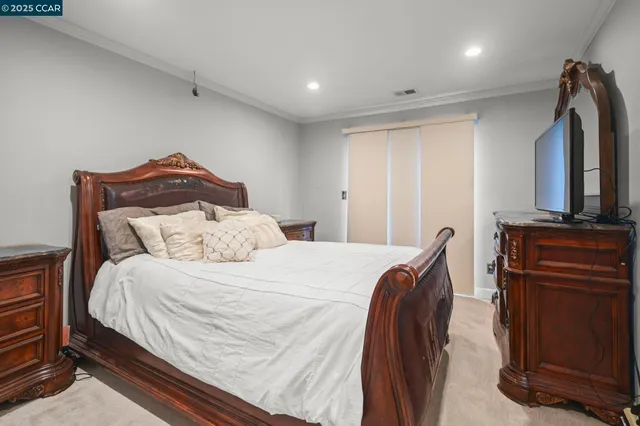 a bedroom with a bed and a television