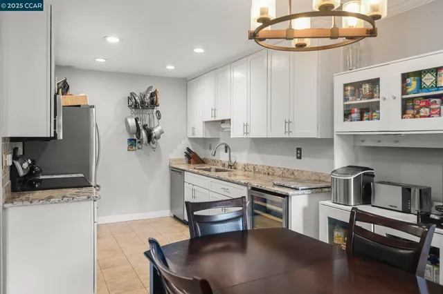 a kitchen with stainless steel appliances granite countertop a sink and a stove