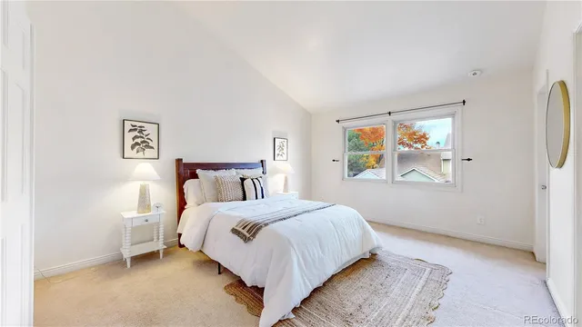 a bedroom with a bed and painting on the wall