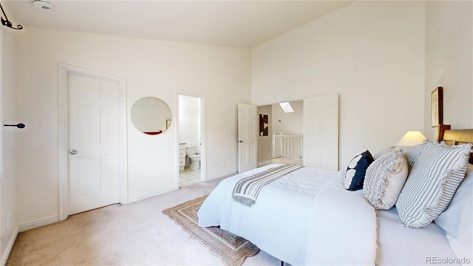 2114 Ranch Drive Denver, CO 80234 - Photo 19 of 48 a bedroom with bed and a chandelier