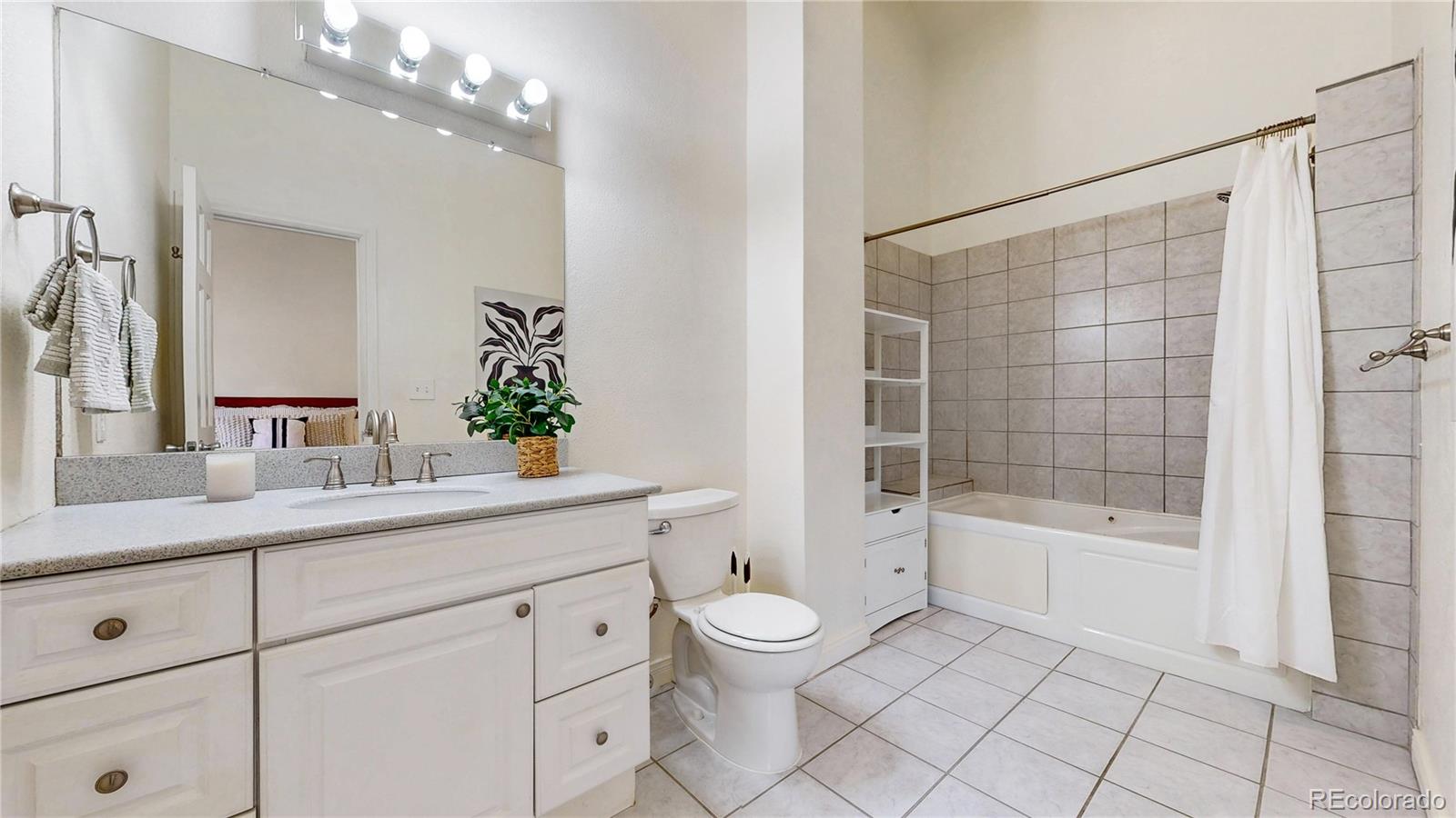 2114 Ranch Drive Denver, CO 80234 - Photo 20 of 48 a bathroom with a bathtub shower sink vanity and toilet