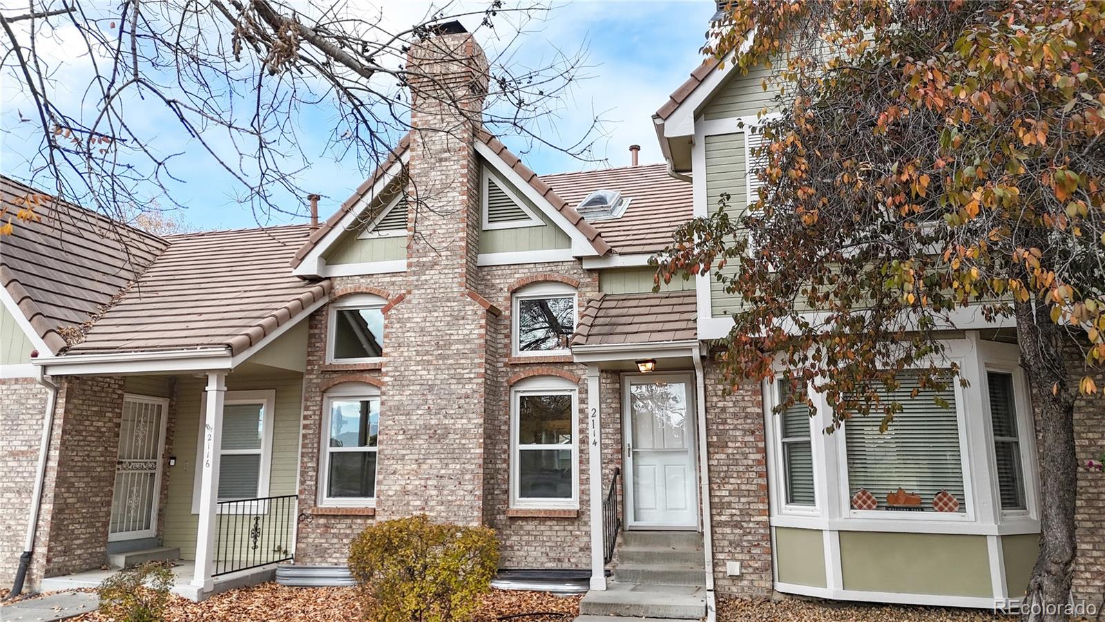 2114 Ranch Drive Denver, CO 80234 - Photo 2 of 48 a front view of a house with garden