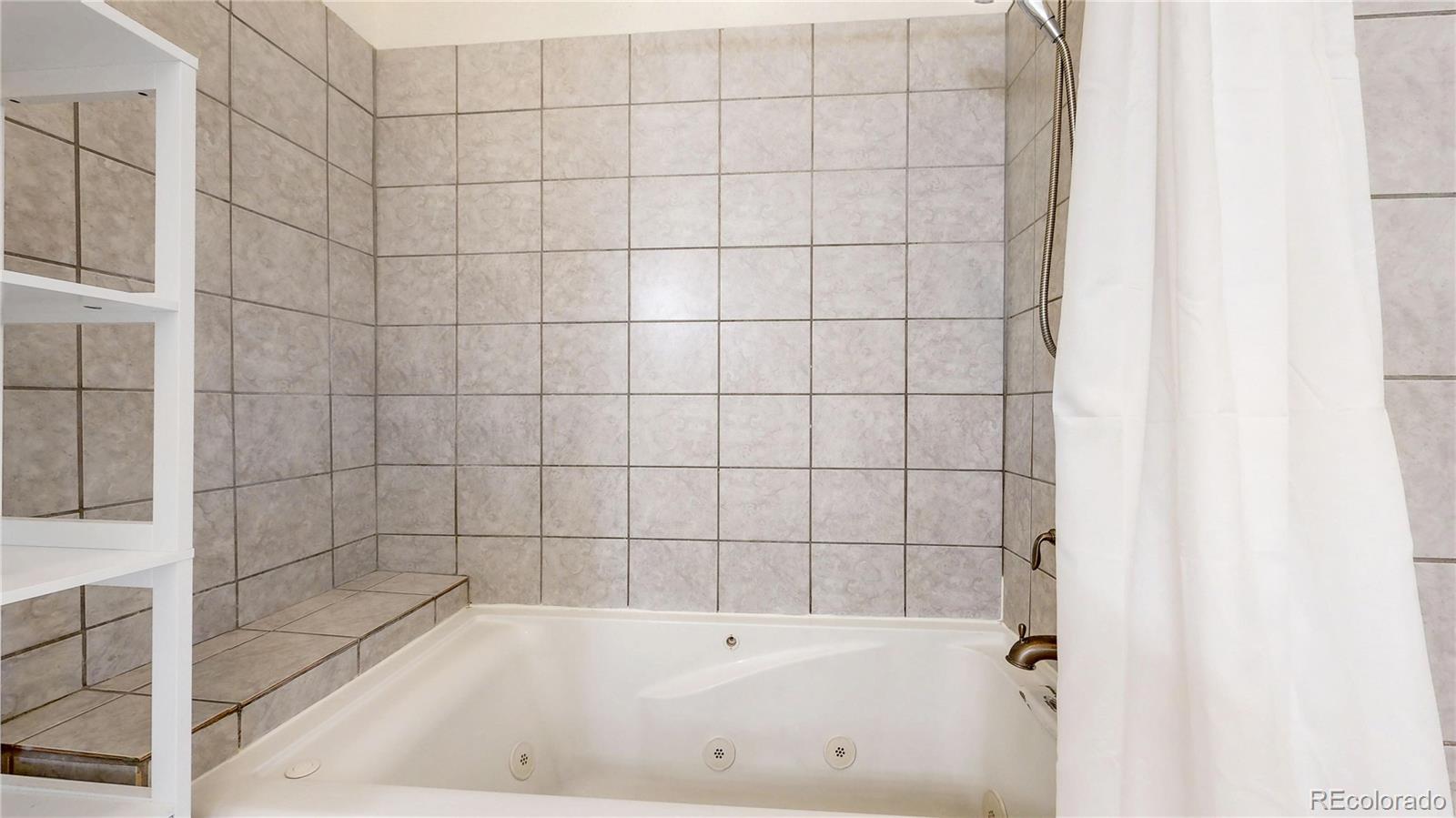 2114 Ranch Drive Denver, CO 80234 - Photo 22 of 48 a bathroom with a bathtub