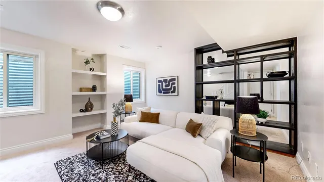 a living room with furniture a rug and a window