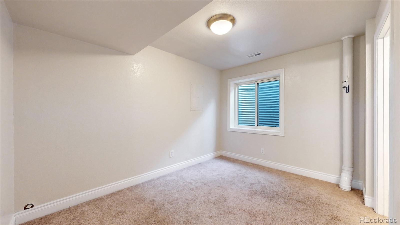 2114 Ranch Drive Denver, CO 80234 - Photo 27 of 48 an empty room with a window