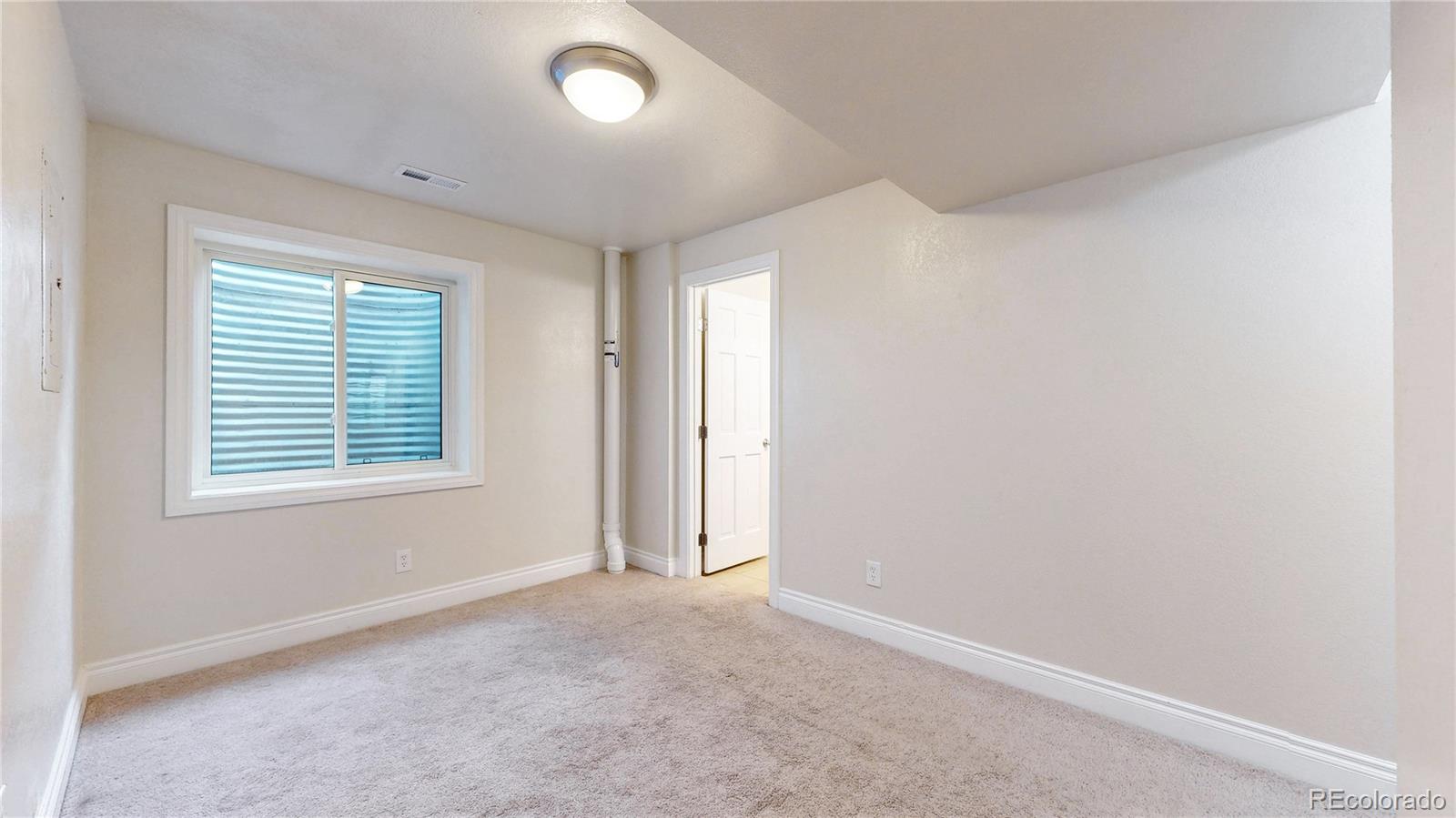 2114 Ranch Drive Denver, CO 80234 - Photo 29 of 48 an empty room with a window