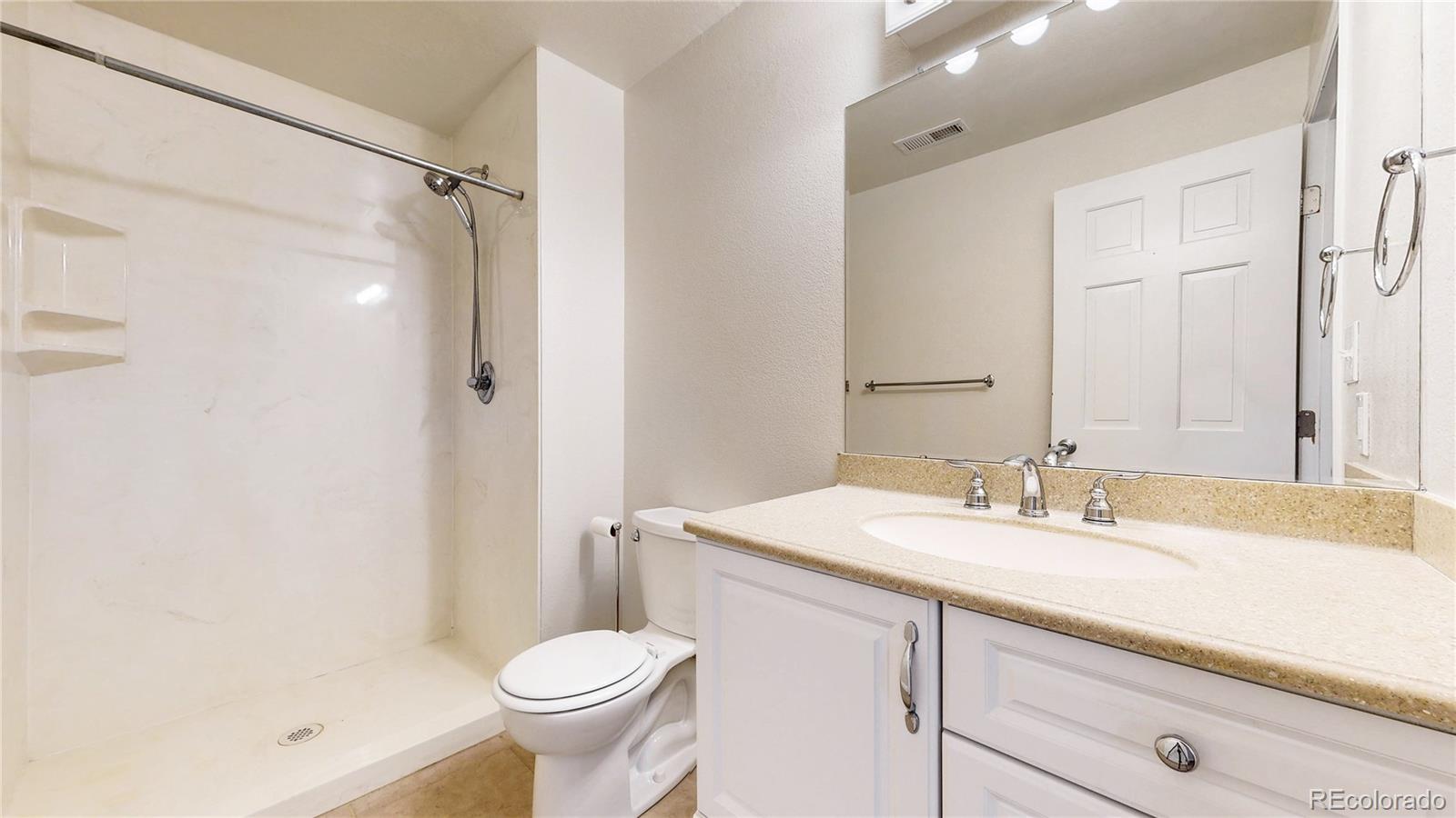 2114 Ranch Drive Denver, CO 80234 - Photo 30 of 48 a bathroom with a sink toilet and shower