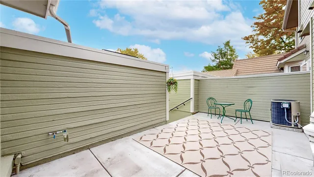 a backyard of a house with table and chairs