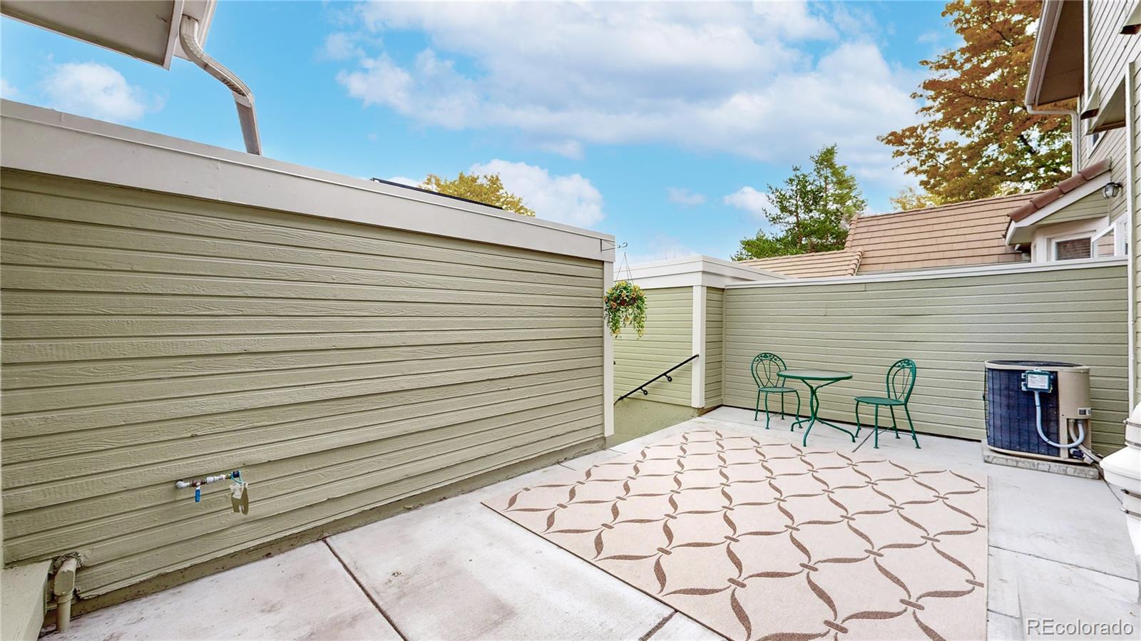 2114 Ranch Drive Denver, CO 80234 - Photo 34 of 48 a backyard of a house with table and chairs