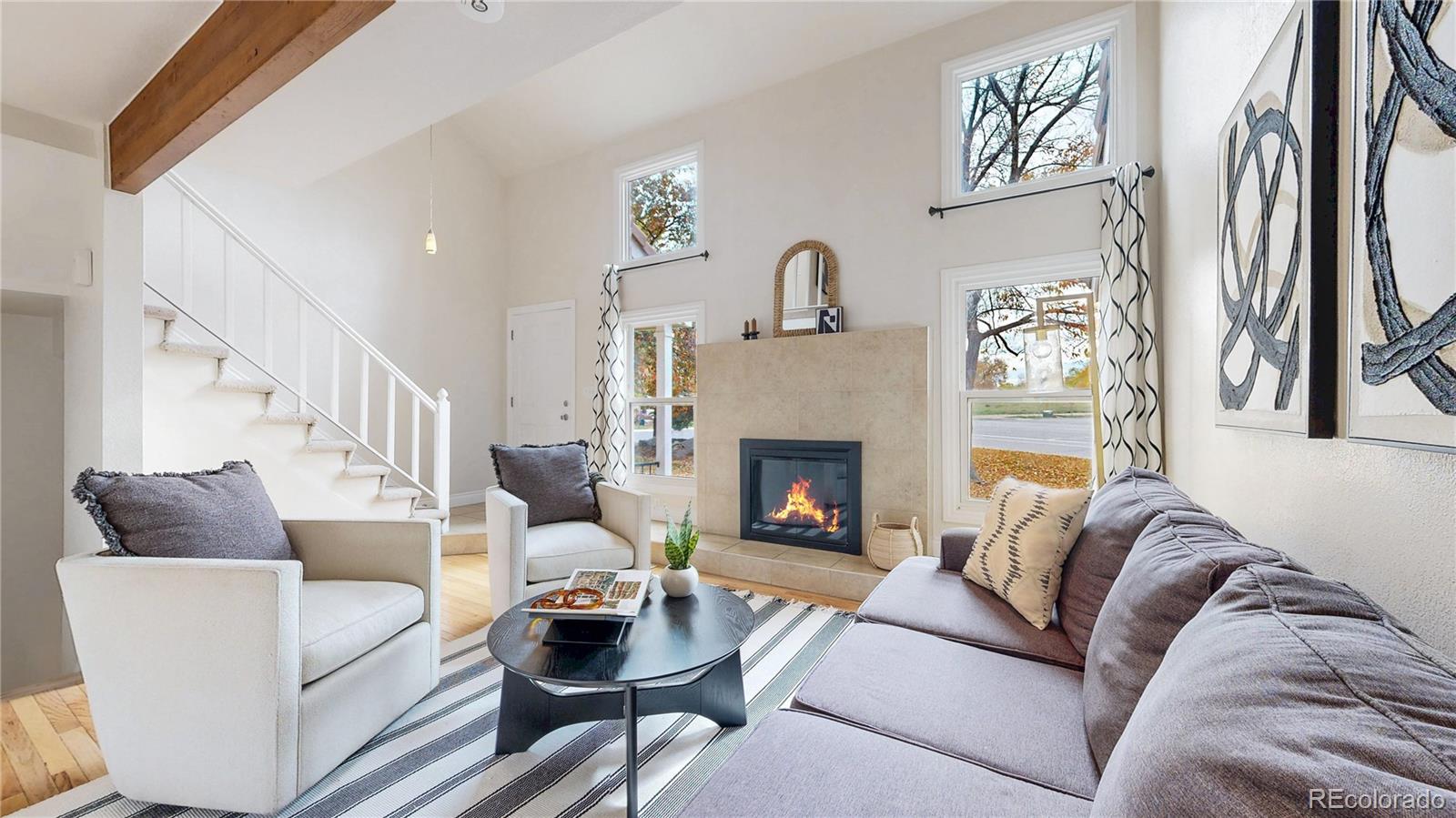 2114 Ranch Drive Denver, CO 80234 - Photo 4 of 48 a living room with furniture and a fireplace