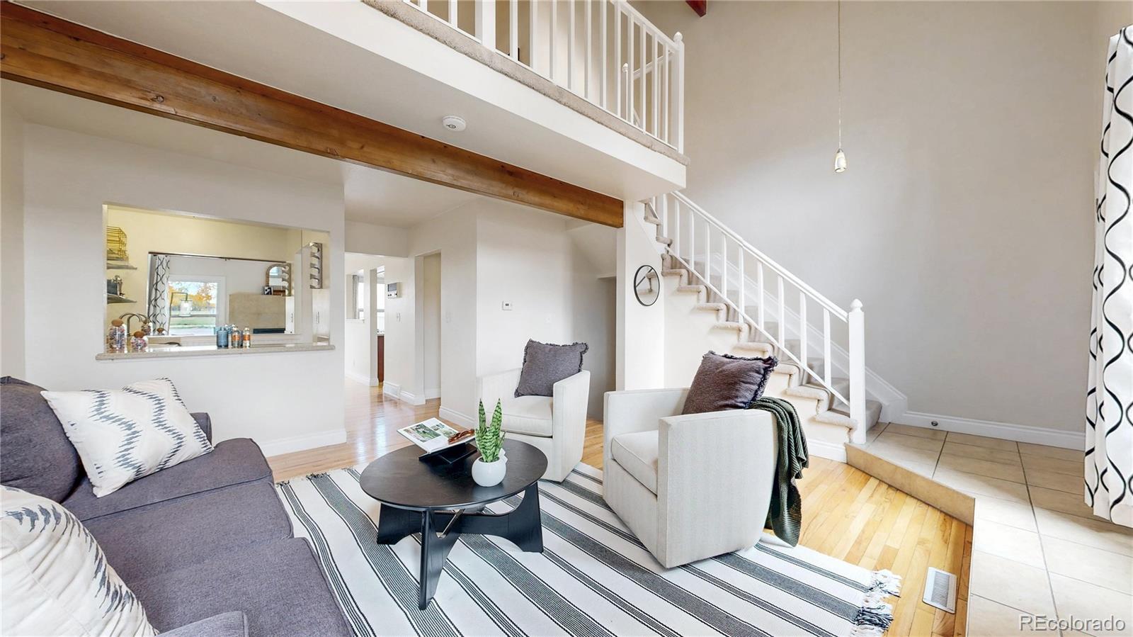 2114 Ranch Drive Denver, CO 80234 - Photo 5 of 48 a living room with furniture and a table