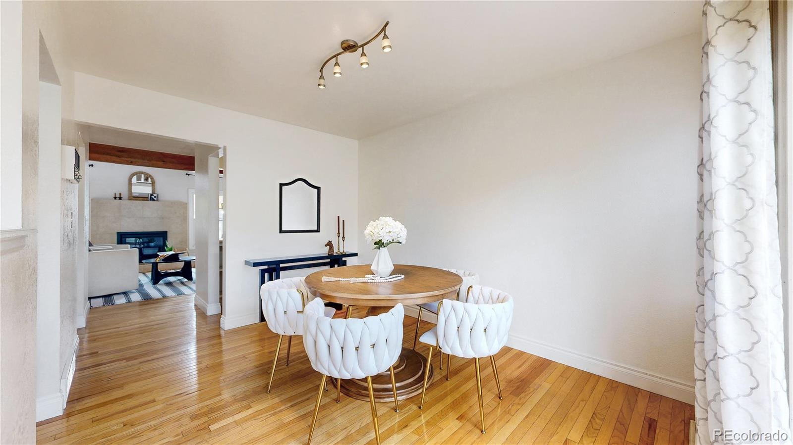 2114 Ranch Drive Denver, CO 80234 - Photo 6 of 48 a dining room with furniture and wooden floor