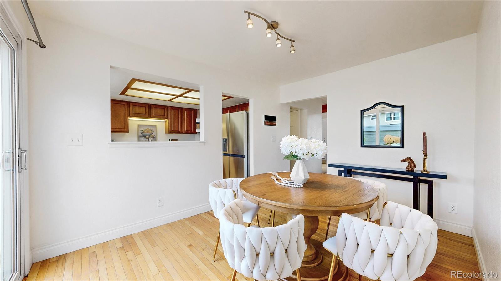 2114 Ranch Drive Denver, CO 80234 - Photo 7 of 48 a view of a dining room with furniture and wooden floor