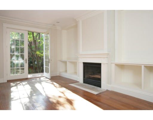 a living room with a fireplace and a floor to ceiling window