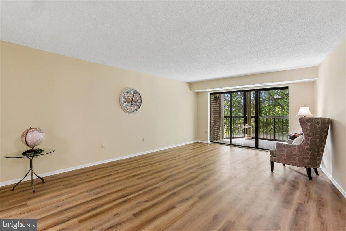 15101 Interlachen Drive, Unit 1614 Silver Spring, MD 20906 - Photo 8 of 41 Living room flows into sunroom