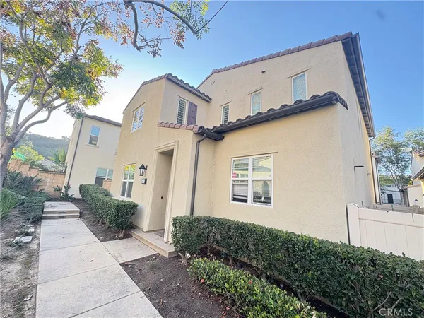 a view of a house with a plants and a tree