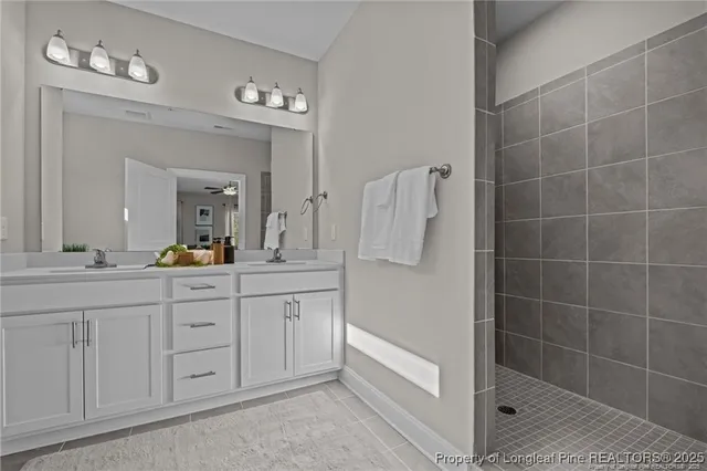 a spacious bathroom with a double vanity sink a mirror and a bathtub