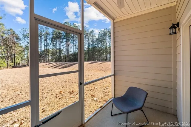 a view of a room with wooden floor and chair