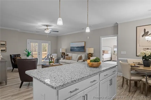 a kitchen with granite countertop a counter space dining table and chairs