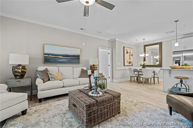 a living room with furniture potted plant and white walls