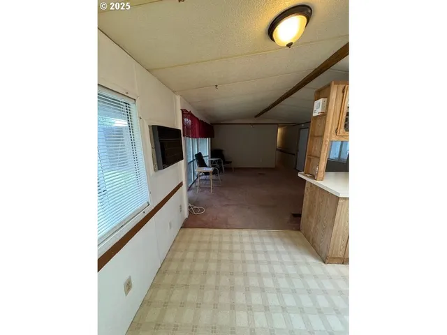 a kitchen with stainless steel appliances a refrigerator and cabinets