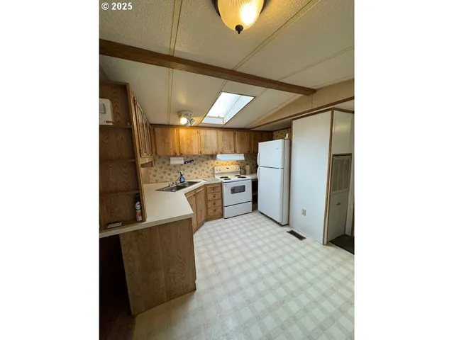 a kitchen with stainless steel appliances granite countertop a sink and cabinets