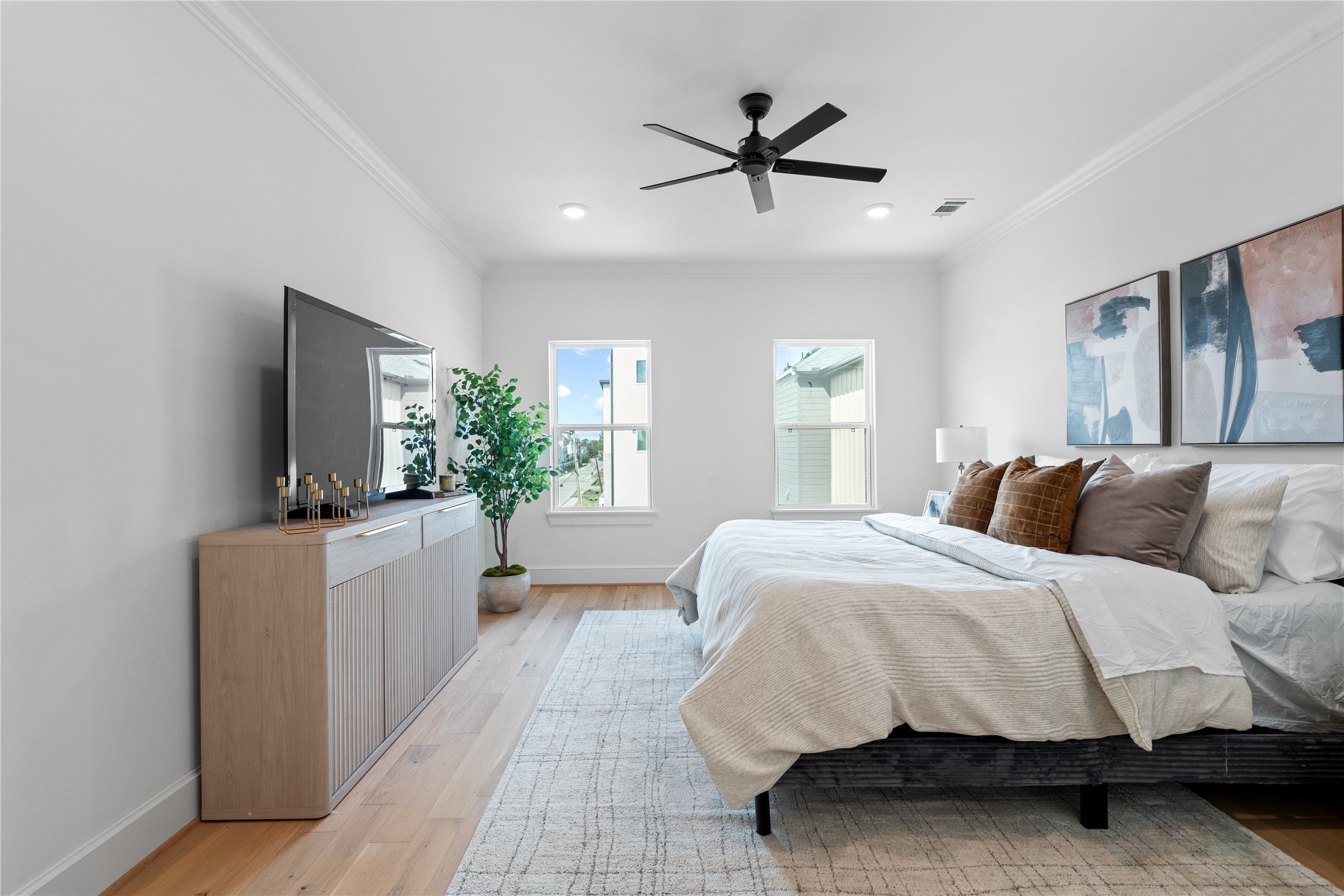 1614 Ojeman Road, Unit I Houston, TX 77055 - Photo 29 of 49 Spacious primary bedroom on the third floor featuring hardwood floors, ample natural light, and a serene atmosphere - perfect for relaxing at the end of the day.