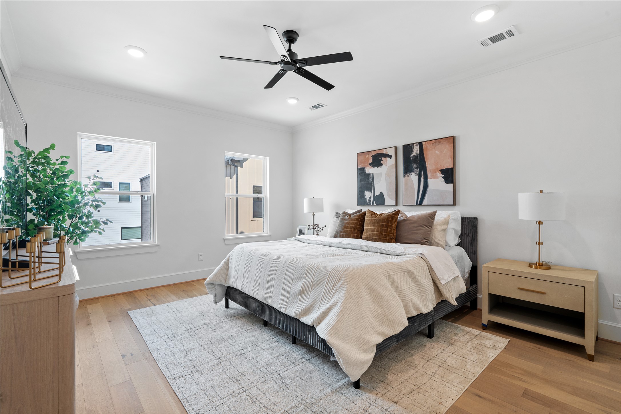 1614 Ojeman Road, Unit I Houston, TX 77055 - Photo 30 of 49 A bright and airy primary bedroom highlighted by designer touches, white oak flooring, and a serene ambiance ideal for unwinding in style.