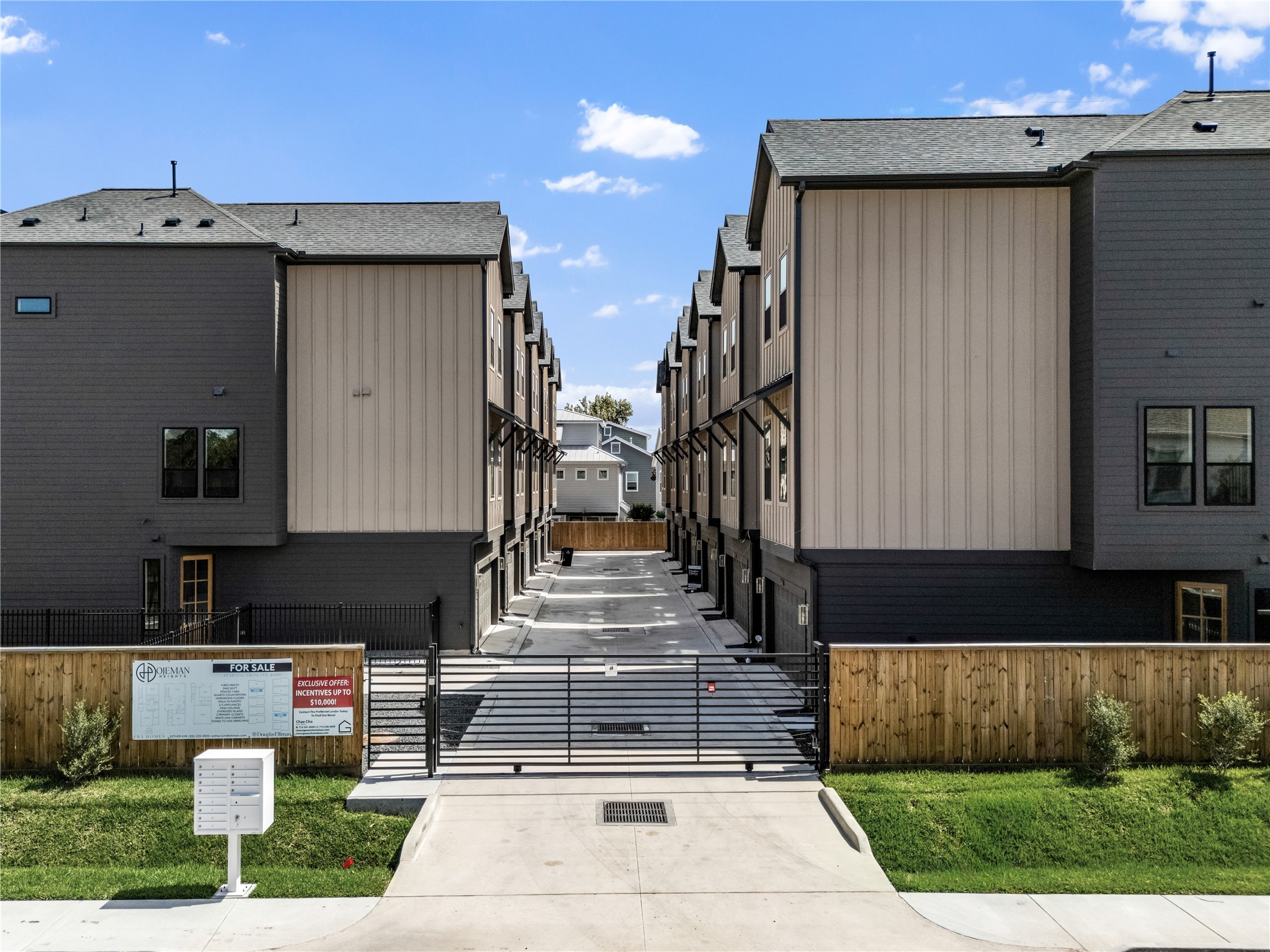 1614 Ojeman Road, Unit I Houston, TX 77055 - Photo 48 of 49 Modern 11-unit complex with a gated entrance, featuring multiple three-story units. The exterior showcases a sleek, contemporary design with contrasting dark and light panels.
