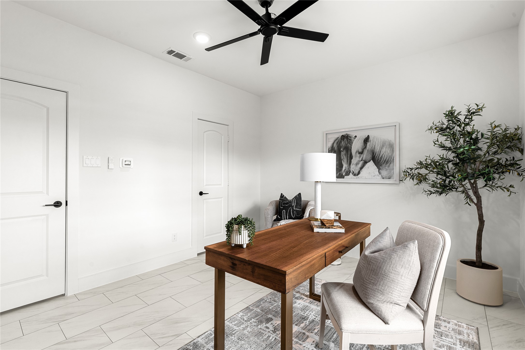 1614 Ojeman Road, Unit I Houston, TX 77055 - Photo 8 of 49 Versatile bedroom featuring spacious walk-in closet - perfect as a guest bedroom or home office. Sleek tile floors and modern finishes complete the polished look.