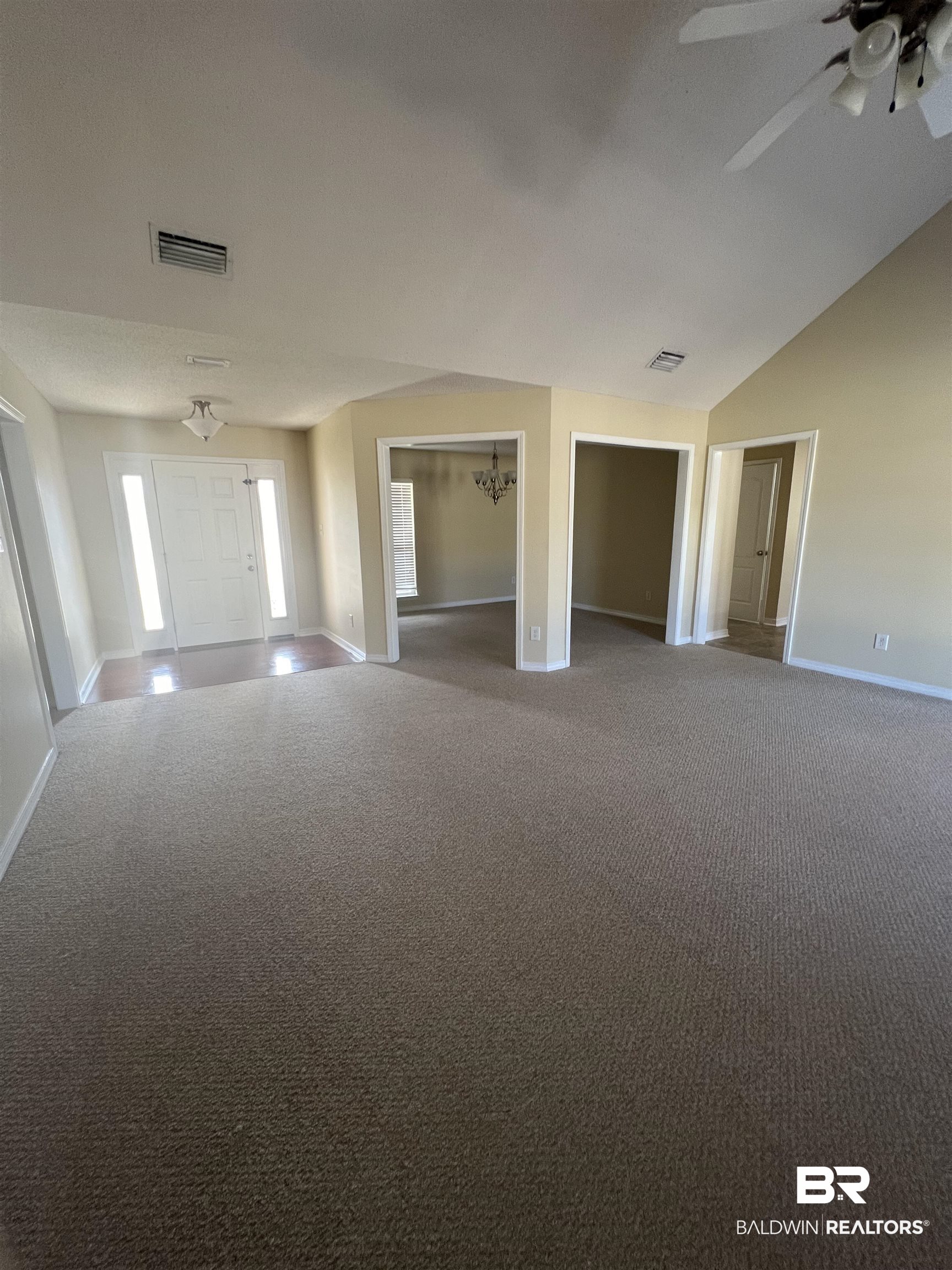 17793 Fancy Boulevard Foley, AL 36535 - Photo 4 of 34 Carpeted empty room featuring vaulted ceiling and ceiling fan